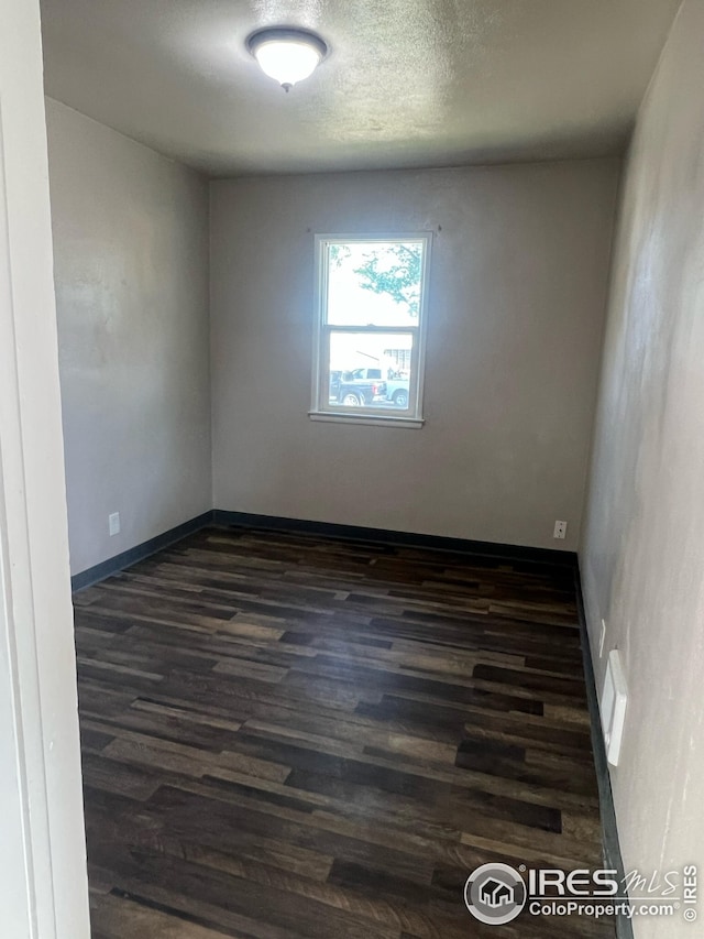 351 E 2nd St, Akron, CO 80720 - unfurnished room with dark wood-type flooring and baseboards