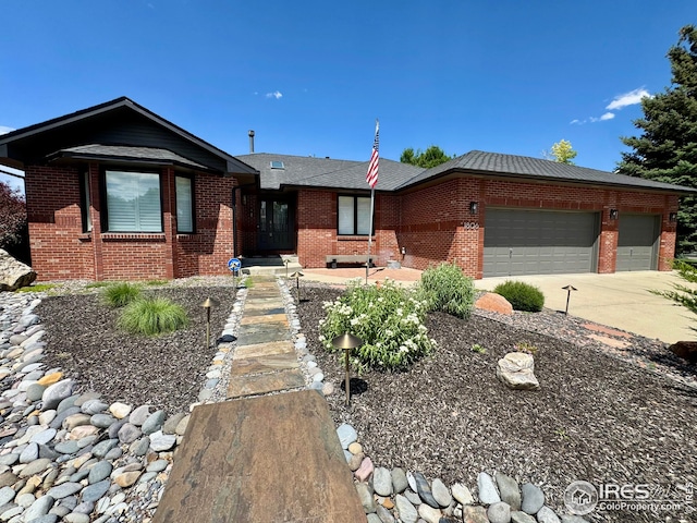 1806 Crestone Ct, Longmont, CO 80504 - ranch-style house with brick siding, concrete driveway, and an attached garage