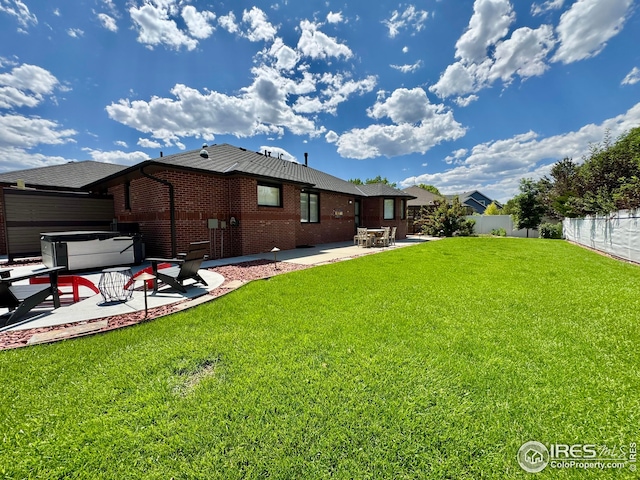 1806 Crestone Ct, Longmont, CO 80504 - back of property with a patio area, brick siding, and a hot tub