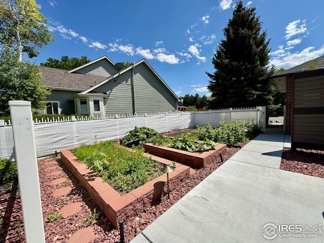 1806 Crestone Ct, Longmont, CO 80504 - view of home's exterior with a garden and a shingled roof