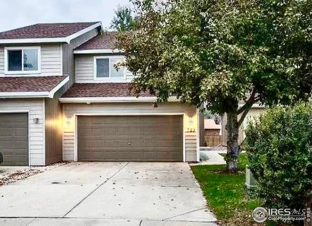 723 2nd St, Windsor, CO 80550 - view of property featuring an attached garage, concrete driveway, and a shingled roof