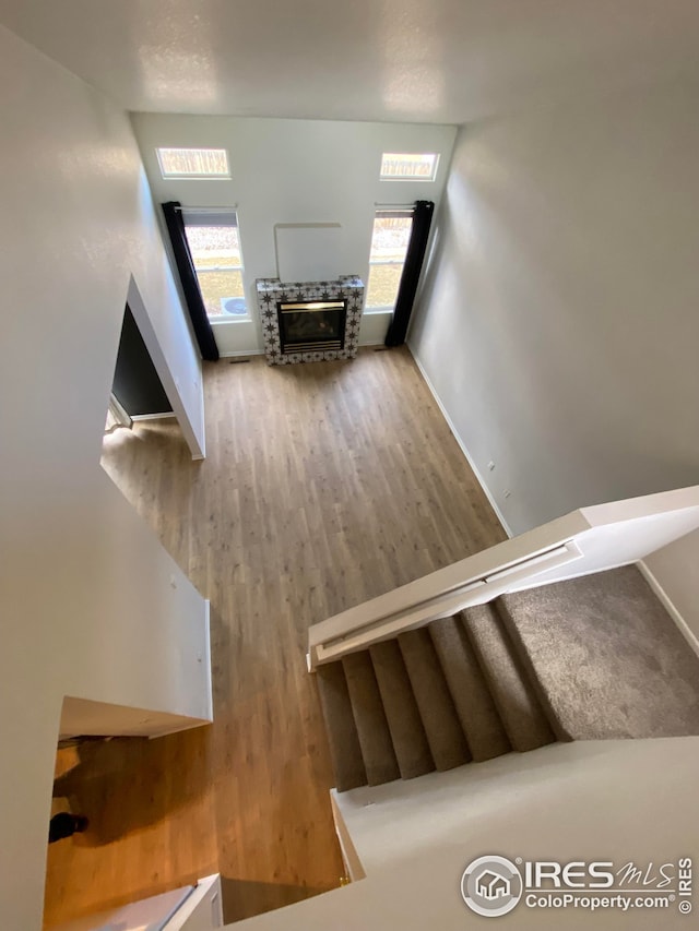 723 2nd St, Windsor, CO 80550 - unfurnished living room featuring wood finished floors, plenty of natural light, and a glass covered fireplace
