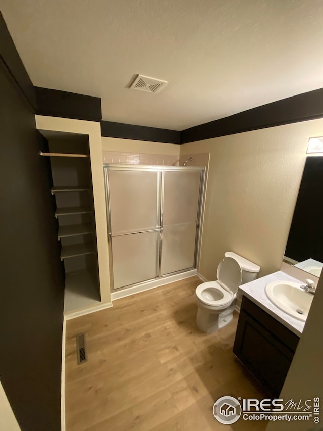 723 2nd St, Windsor, CO 80550 - bathroom with vanity, a stall shower, and wood finished floors