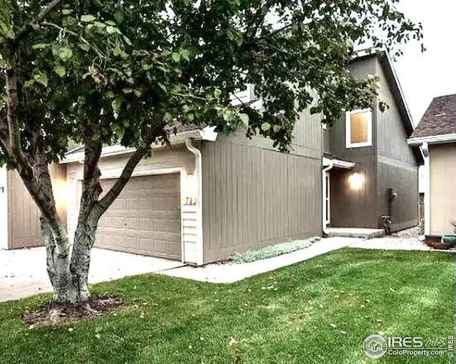 723 2nd St, Windsor, CO 80550 - view of property exterior with a garage, a lawn, and driveway