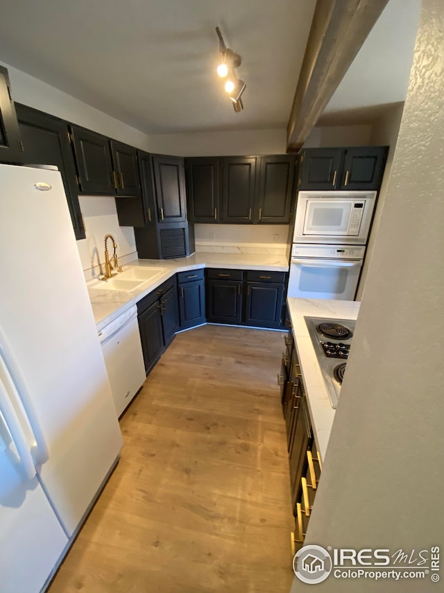 723 2nd St, Windsor, CO 80550 - kitchen with white appliances, light wood-type flooring, and light countertops