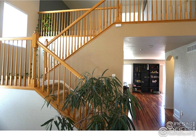 12609 Jersey Cir W, Thornton, CO 80602 - stairs with wood finished floors and arched walkways