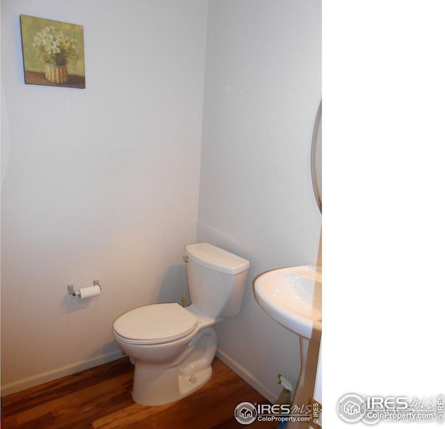 12609 Jersey Cir W, Thornton, CO 80602 - half bath featuring toilet and wood finished floors