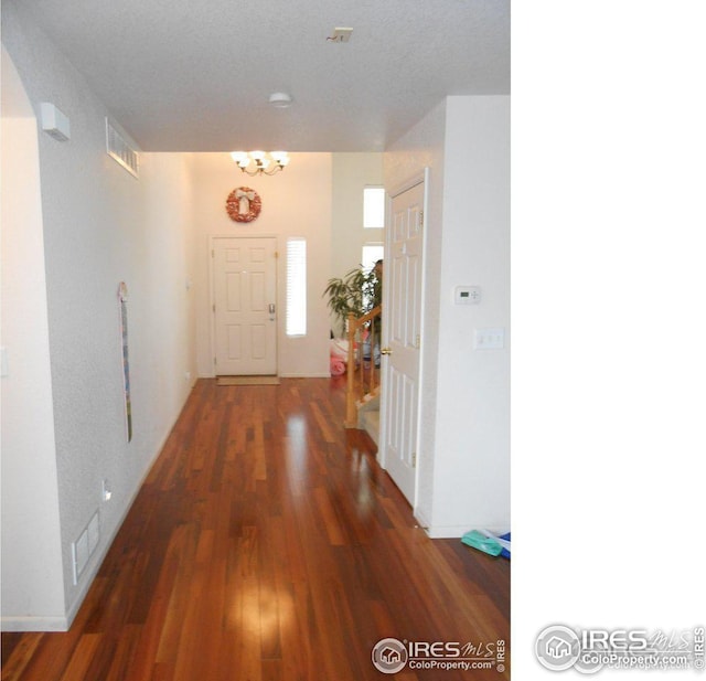 12609 Jersey Cir W, Thornton, CO 80602 - hall featuring wood finished floors and a chandelier