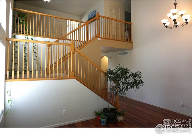 12609 Jersey Cir W, Thornton, CO 80602 - stairs featuring wood finished floors and a chandelier