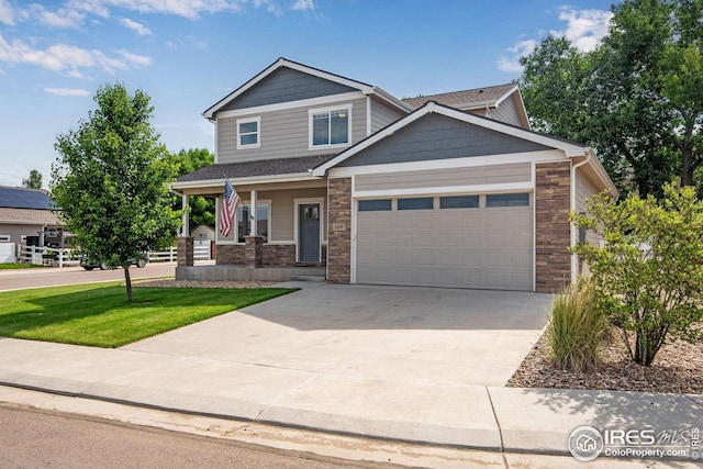 108 Wake St, Frederick, CO 80530 - craftsman inspired home with stone siding, an attached garage, driveway, covered porch, and a front lawn