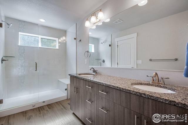 108 Wake St, Frederick, CO 80530 - bathroom featuring a shower stall, healthy amount of natural light, and double vanity