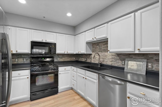 14300 Waterside Ln Unit E3, Broomfield, CO 80023 - kitchen featuring black appliances, dark countertops, white cabinetry, decorative backsplash, and recessed lighting