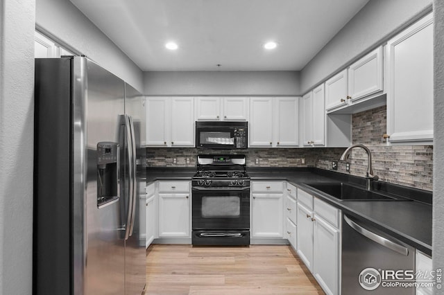 14300 Waterside Ln Unit E3, Broomfield, CO 80023 - kitchen featuring black appliances, dark countertops, light wood-style floors, white cabinets, and recessed lighting