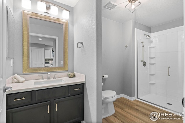 14300 Waterside Ln Unit E3, Broomfield, CO 80023 - bathroom featuring a stall shower, vanity, and wood finished floors