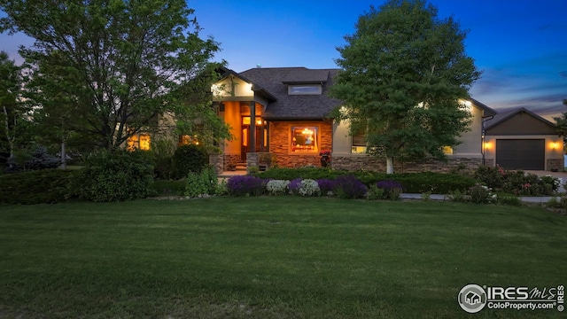 37080 Soaring Eagle Cir, Severance, CO 80550 - view of front of home with stone siding, a lawn, and a garage