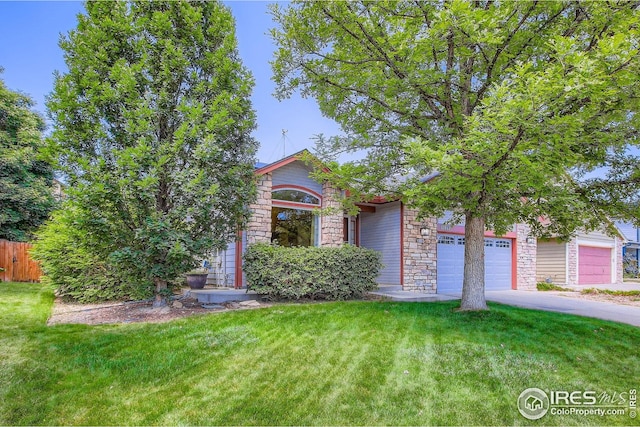 10947 W 100th Dr, Westminster, CO 80021 - view of property hidden behind natural elements with stone siding, an attached garage, and driveway
