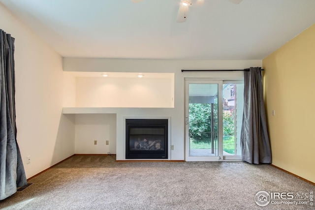 10947 W 100th Dr, Westminster, CO 80021 - unfurnished living room featuring carpet flooring, a glass covered fireplace, and a ceiling fan