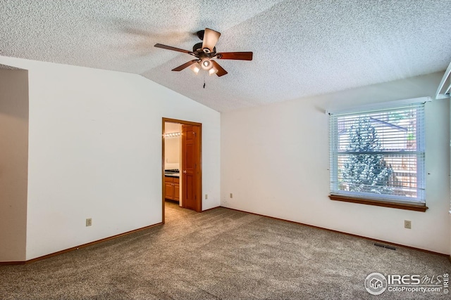 10947 W 100th Dr, Westminster, CO 80021 - spare room with a ceiling fan, light colored carpet, vaulted ceiling, and a textured ceiling