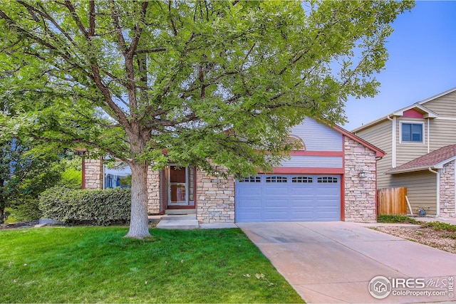10947 W 100th Dr, Westminster, CO 80021 - view of property hidden behind natural elements featuring an attached garage, stone siding, and driveway