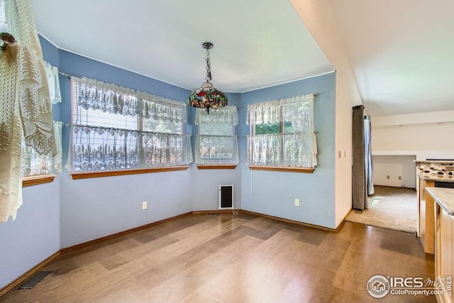 10947 W 100th Dr, Westminster, CO 80021 - unfurnished dining area featuring baseboards and wood finished floors