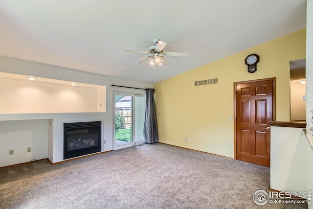 10947 W 100th Dr, Westminster, CO 80021 - unfurnished living room featuring vaulted ceiling, a ceiling fan, a glass covered fireplace, and carpet