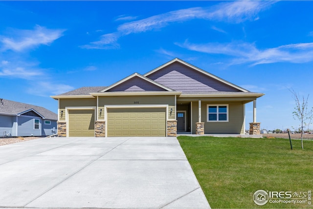 view of front of home with a front yard and a garage