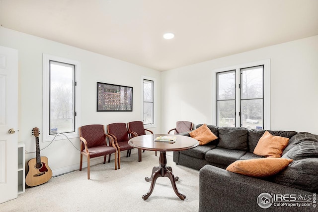 living room with light carpet and a healthy amount of sunlight