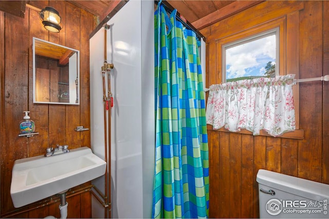 bathroom featuring wood walls, toilet, and wood ceiling