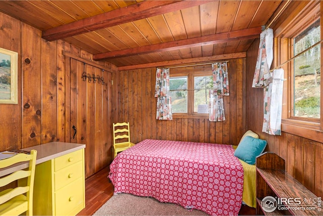 bedroom with wood walls, beam ceiling, and dark hardwood / wood-style floors