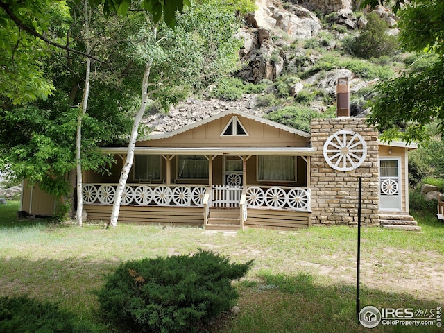 view of front of home with a front yard and a porch