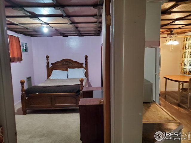 bedroom with carpet and white fridge