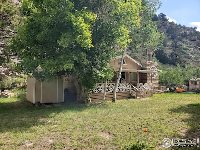 32246 Poudre Canyon Hwy, Bellvue, CO 80512 - view of front of home with a porch and a front yard