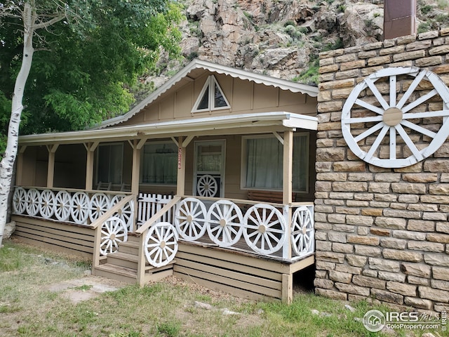 32246 Poudre Canyon Hwy, Bellvue, CO 80512 - view of front of home featuring covered porch and board and batten siding