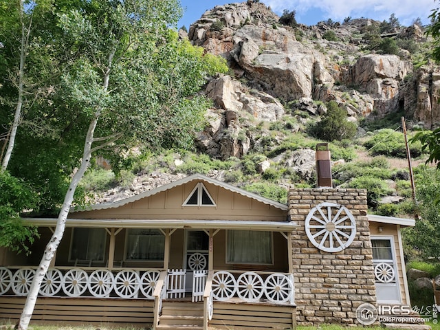 32246 Poudre Canyon Hwy, Bellvue, CO 80512 - view of front of house featuring covered porch