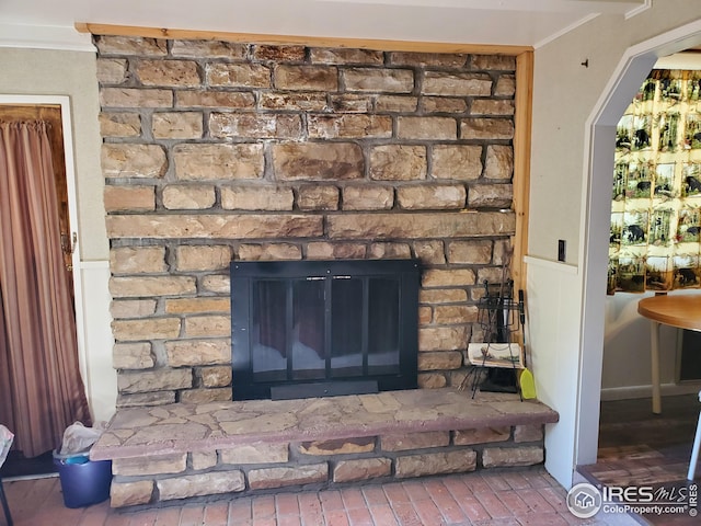 interior details with ornamental molding and a fireplace