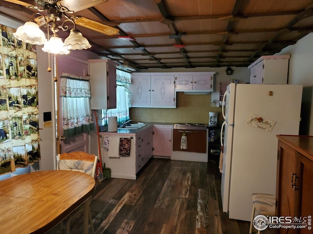 kitchen with white cabinetry, dark wood-type flooring, white refrigerator, backsplash, and ceiling fan