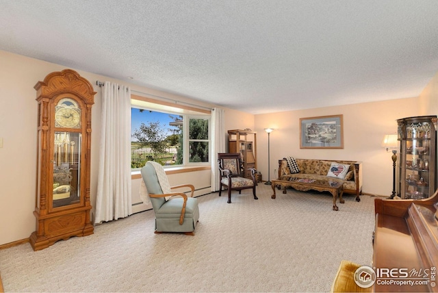 carpeted living room with a baseboard radiator and a textured ceiling