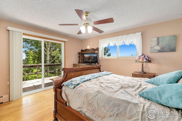 bedroom featuring light wood-type flooring, ceiling fan, access to outside, and a textured ceiling