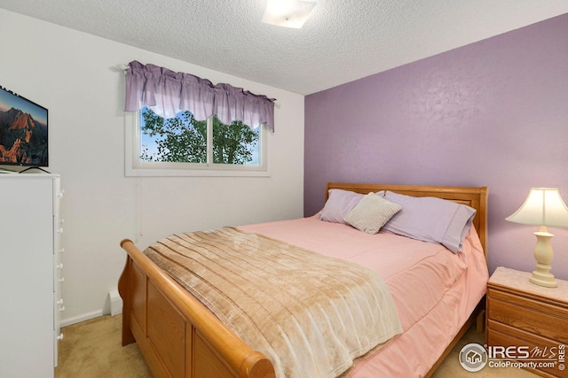 carpeted bedroom with a textured ceiling