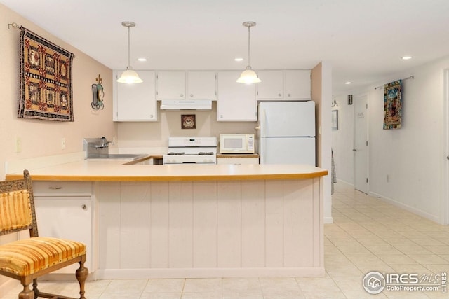 kitchen featuring hanging light fixtures, light tile patterned floors, sink, kitchen peninsula, and white appliances