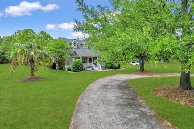 cape cod home featuring a front yard, covered porch, and aphalt driveway