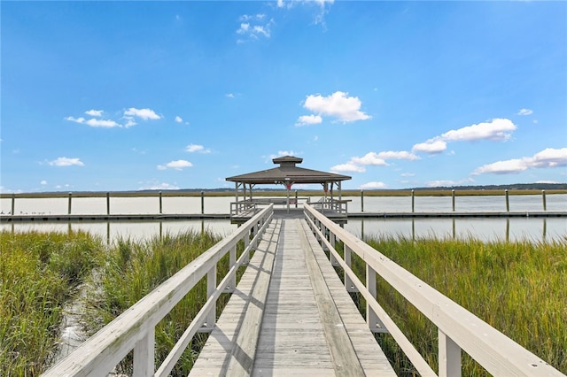 view of dock with a gazebo and a water view