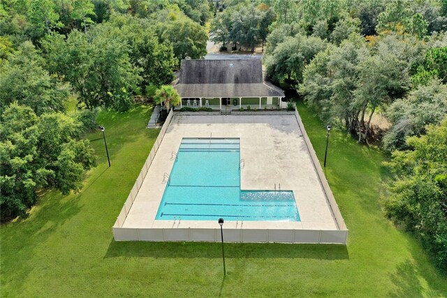 community pool featuring a lawn