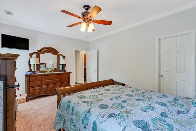 carpeted bedroom featuring a ceiling fan, visible vents, and ornamental molding