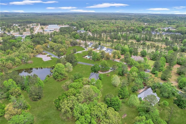 drone / aerial view featuring a forest view and a water view