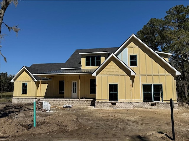 view of front of home with a standing seam roof, board and batten siding, and metal roof