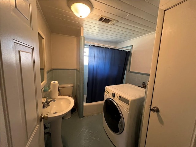 4442 Brunswick Hwy, Waycross, GA 31503 - full bathroom with tile walls, a wainscoted wall, visible vents, washer / clothes dryer, and a shower with curtain