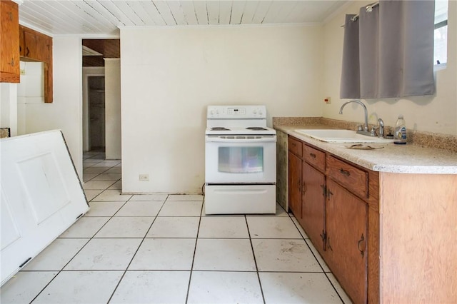 4442 Brunswick Hwy, Waycross, GA 31503 - kitchen with light tile patterned flooring, light countertops, a sink, white electric stove, and brown cabinets