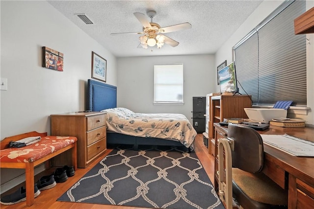 125 Enterprise St, Brunswick, GA 31525 - bedroom with wood finished floors, a desk, a textured ceiling, and ceiling fan