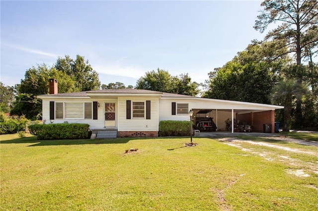 300 Community Dr, Waycross, GA 31501 - view of front of home with an attached carport, a chimney, driveway, and a front lawn